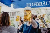 Guests raising beer steins during a Black Forest Brooklyn Oktoberfest celebration.